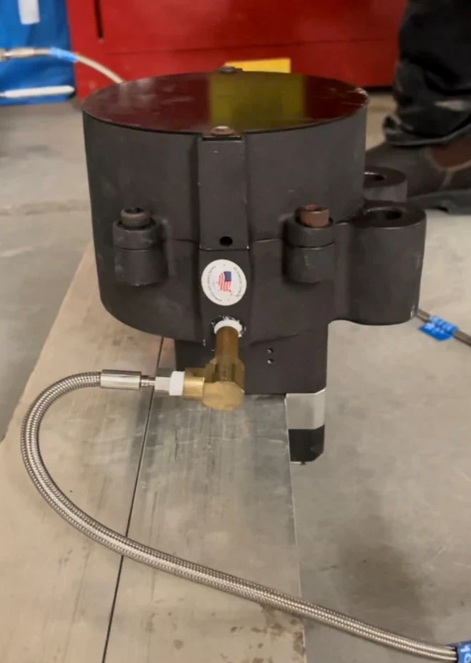 Pneumatic brake caliper clamped around a replica I-beam after the circuit was depressurized